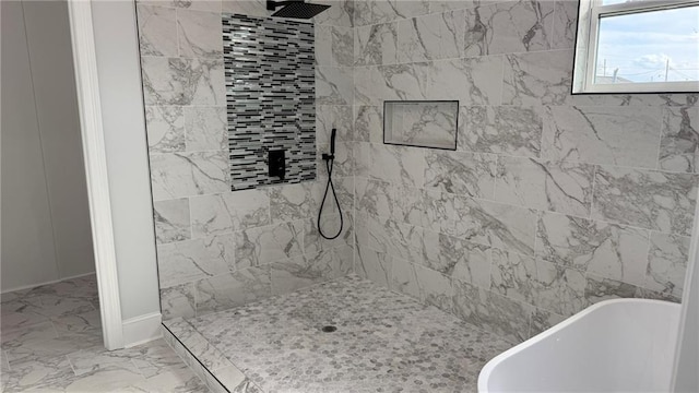 bathroom with tiled shower, marble finish floor, and a freestanding bath