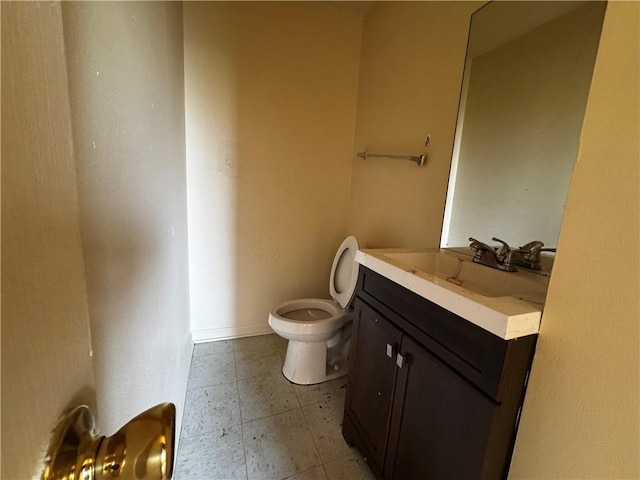 bathroom featuring toilet and vanity