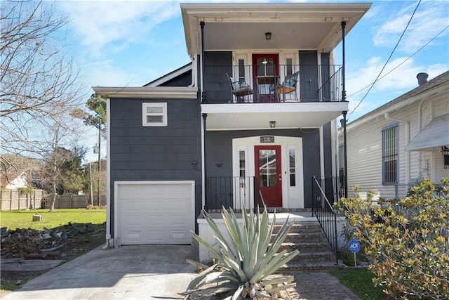 view of front facade with driveway, a porch, fence, a garage, and a balcony