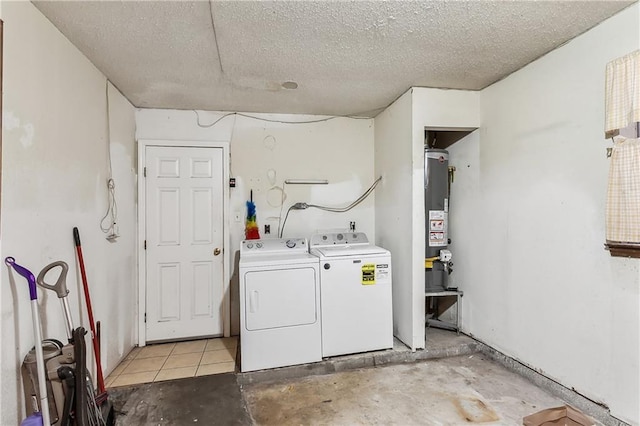 clothes washing area with a textured ceiling, independent washer and dryer, and laundry area