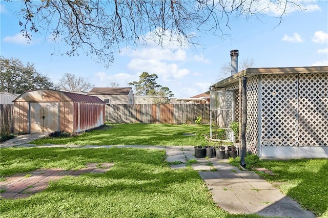 view of yard featuring a fenced backyard, a storage shed, and an outdoor structure