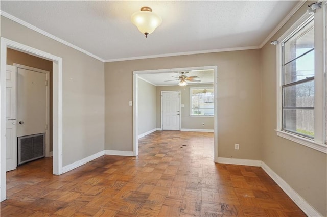 unfurnished room featuring visible vents, baseboards, a textured ceiling, and ornamental molding