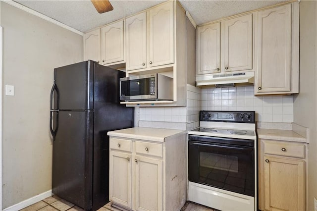 kitchen with under cabinet range hood, stainless steel microwave, electric range oven, freestanding refrigerator, and decorative backsplash