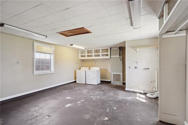 below grade area featuring visible vents, baseboards, and washer and clothes dryer