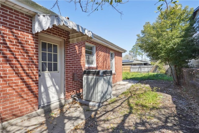 exterior space featuring fence and central AC