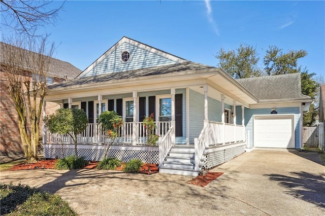 view of front of property with a porch, an attached garage, driveway, and a shingled roof