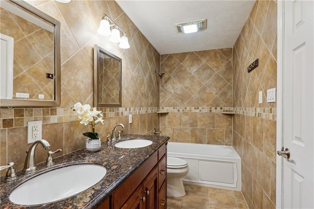 bathroom featuring tile walls, toilet, washtub / shower combination, and a sink