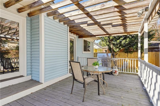 wooden deck featuring outdoor dining area, fence, a grill, and a pergola