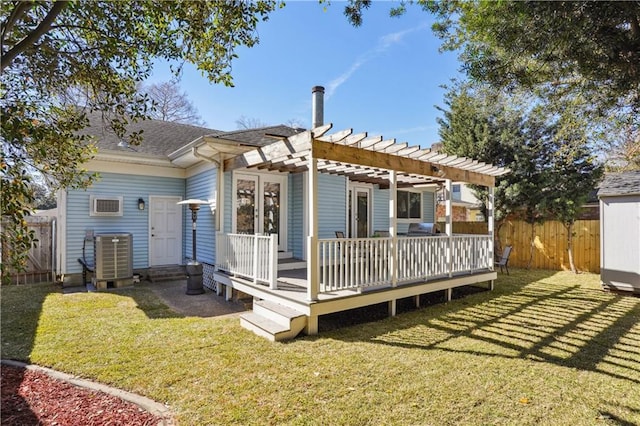 back of property with fence, central AC, a lawn, a deck, and a pergola