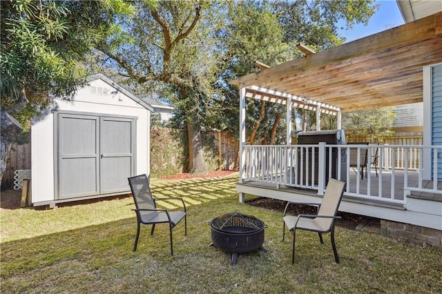 view of yard featuring a pergola, a fire pit, fence, and a shed