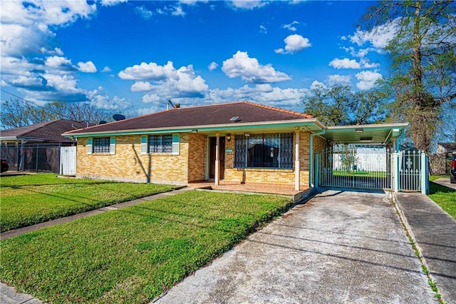 ranch-style house with a gate, fence, concrete driveway, a front yard, and a carport