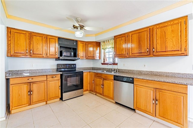 kitchen featuring a ceiling fan, brown cabinetry, a sink, black appliances, and crown molding