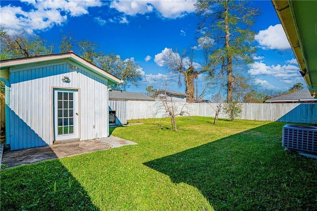 view of yard with cooling unit, an outdoor structure, and a fenced backyard