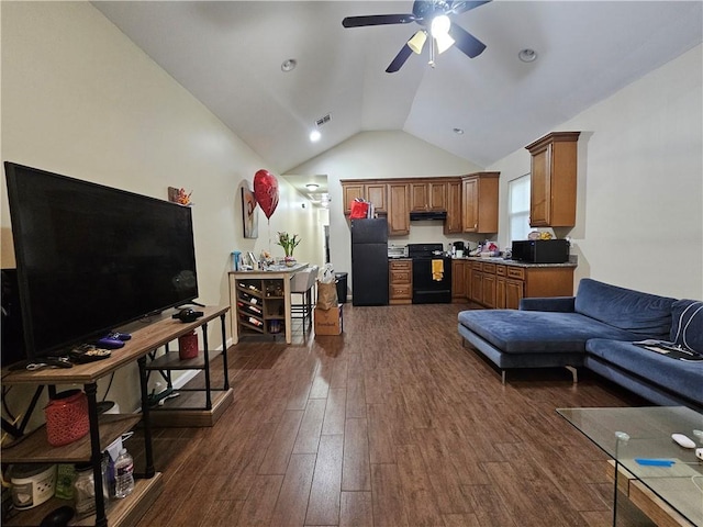 living area with visible vents, ceiling fan, dark wood-style flooring, and vaulted ceiling