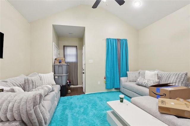 living area with a ceiling fan and vaulted ceiling