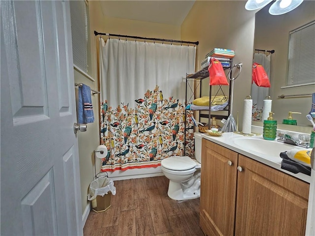 bathroom with toilet, shower / bath combo, wood finished floors, and vanity