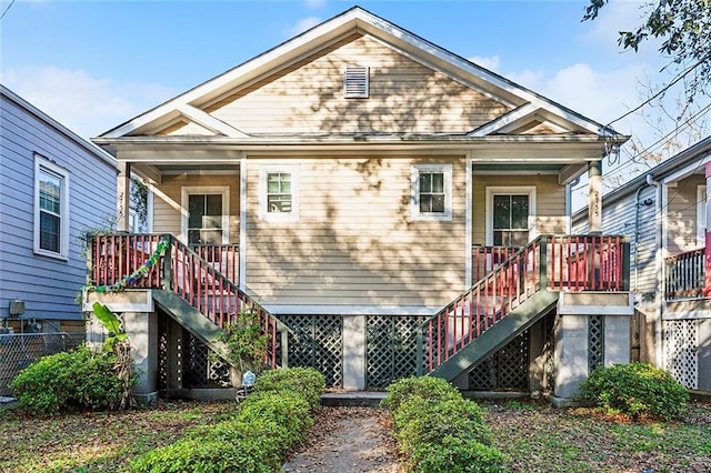 rear view of house with stairway and a porch