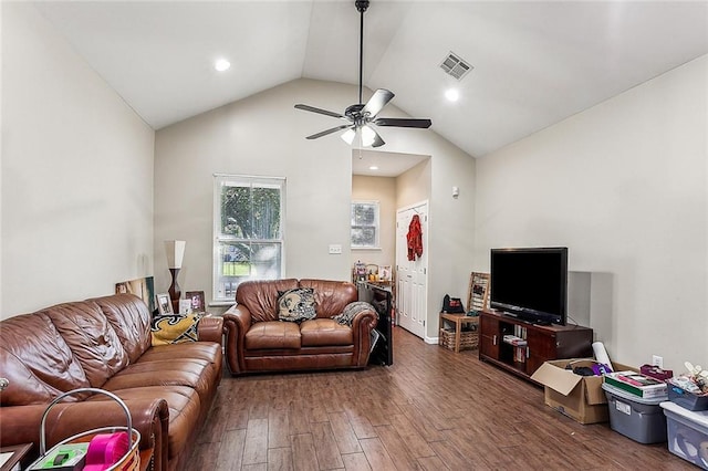 living area featuring visible vents, lofted ceiling, a ceiling fan, and wood finished floors