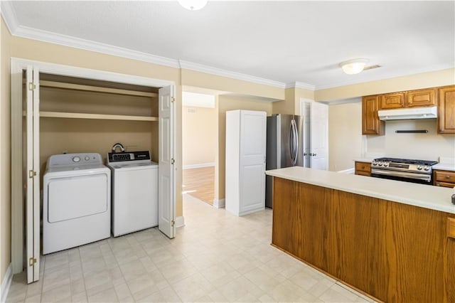 kitchen featuring under cabinet range hood, brown cabinetry, appliances with stainless steel finishes, and light countertops