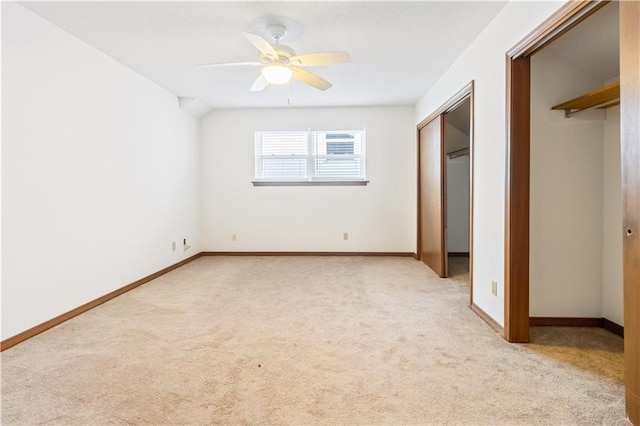 unfurnished bedroom with light colored carpet, baseboards, and ceiling fan