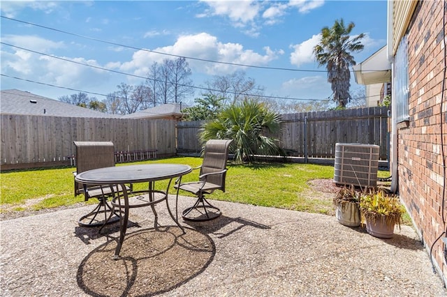 view of yard featuring a fenced backyard, a patio, and central AC