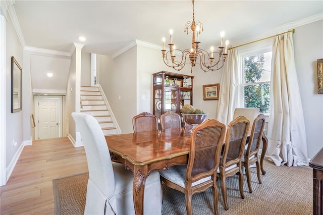 dining area featuring stairway, baseboards, crown molding, and light wood finished floors