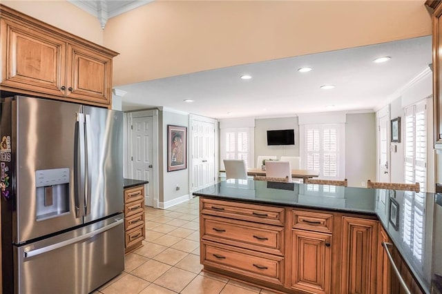 kitchen featuring brown cabinetry, ornamental molding, stainless steel refrigerator with ice dispenser, and light tile patterned floors