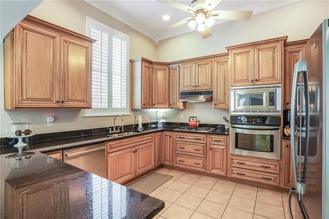 kitchen with under cabinet range hood, a sink, stainless steel appliances, light tile patterned flooring, and crown molding