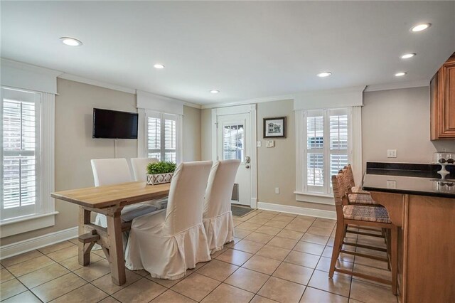 dining room featuring light tile patterned floors, recessed lighting, crown molding, and baseboards