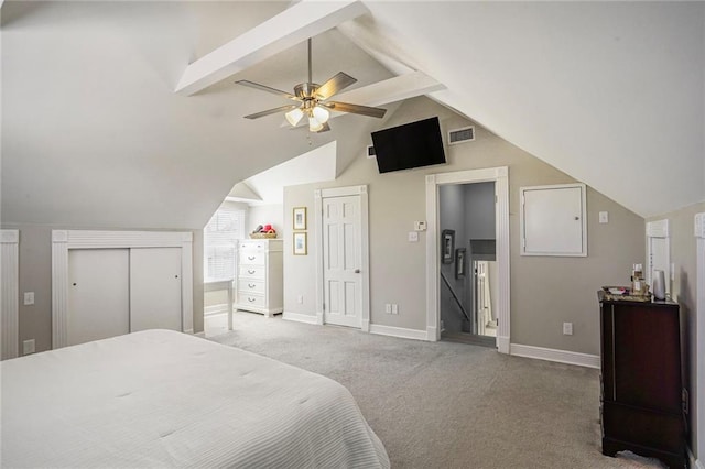 bedroom featuring baseboards, elevator, vaulted ceiling with beams, multiple closets, and light colored carpet