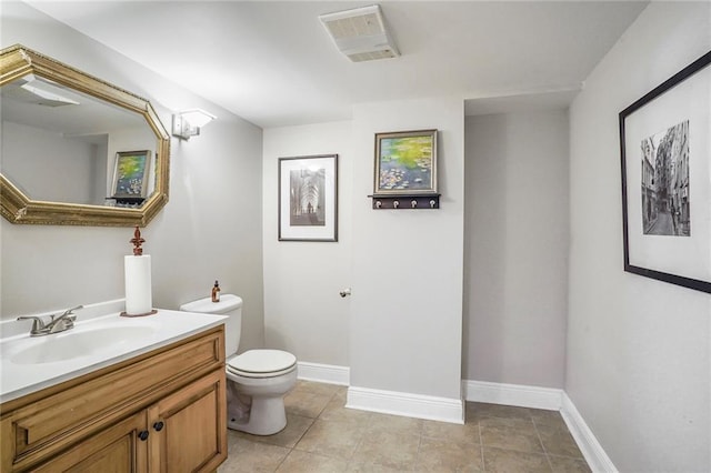 bathroom featuring vanity, baseboards, visible vents, tile patterned floors, and toilet