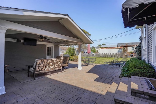 view of patio / terrace featuring outdoor dining area, fence, outdoor dry bar, and ceiling fan