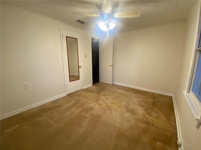 unfurnished bedroom with ceiling fan, visible vents, baseboards, and carpet floors