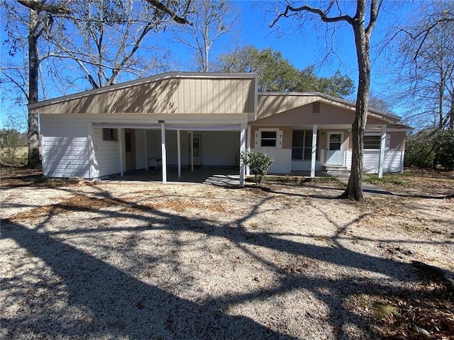 rear view of house with an attached carport