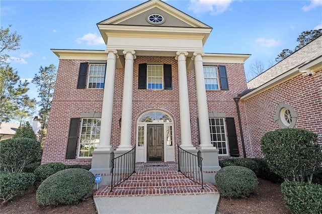 neoclassical / greek revival house with brick siding