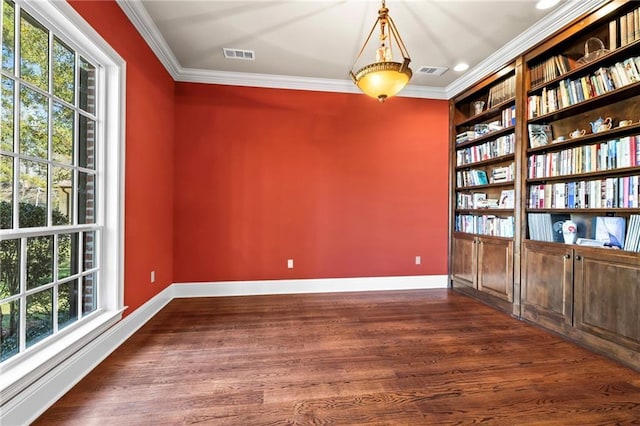 unfurnished room with crown molding, baseboards, and visible vents