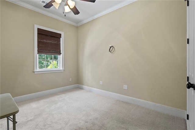 unfurnished room with baseboards, carpet, ceiling fan, and crown molding