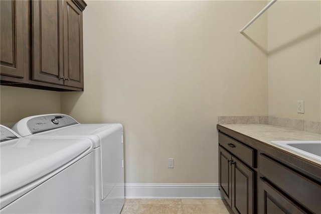 laundry room with cabinet space, baseboards, and washing machine and clothes dryer