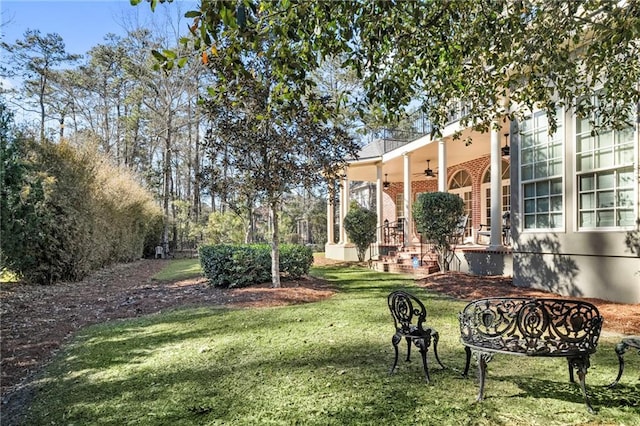 view of yard featuring a ceiling fan