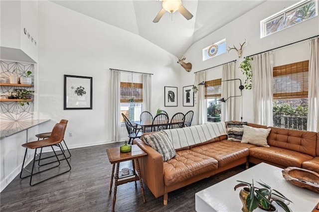 living room with baseboards, high vaulted ceiling, dark wood-style floors, and a ceiling fan