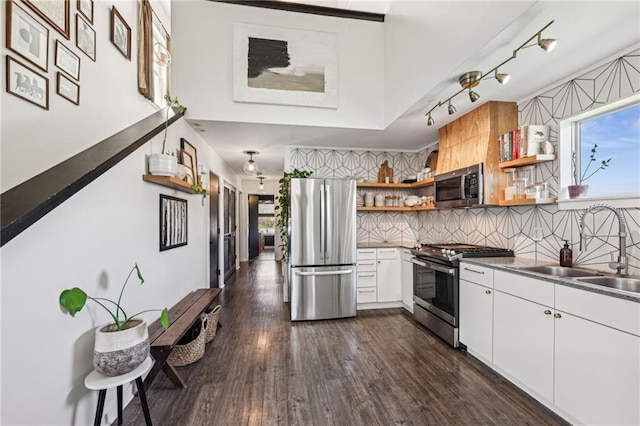 kitchen with open shelves, a sink, tasteful backsplash, stainless steel appliances, and dark wood-style flooring