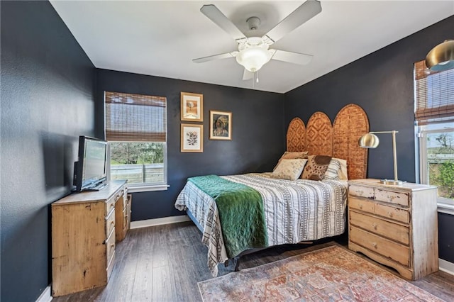 bedroom featuring a ceiling fan, baseboards, and hardwood / wood-style floors