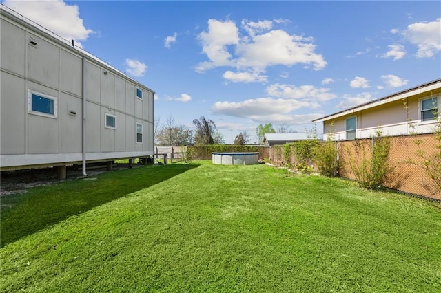 view of yard featuring a fenced in pool and fence