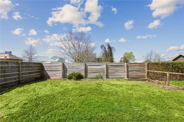 view of yard with a fenced backyard