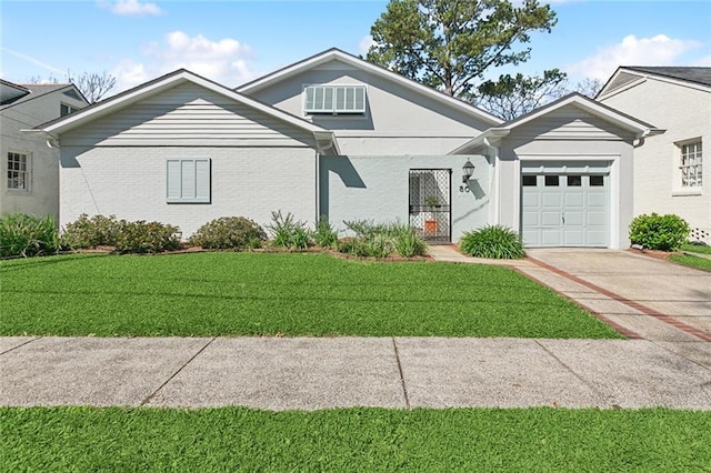 view of front of home with a front yard, a garage, brick siding, and concrete driveway