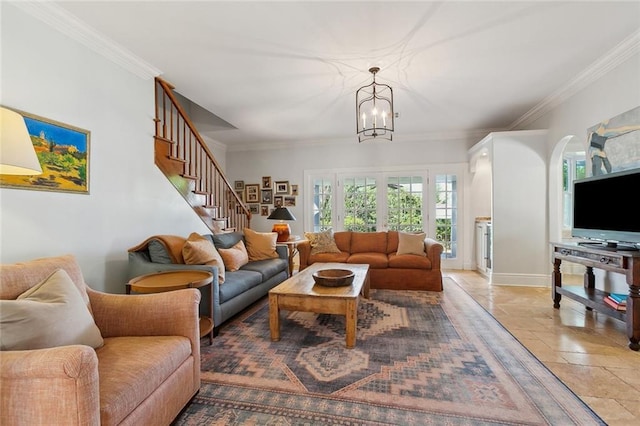 living room featuring stone tile floors, stairway, crown molding, baseboards, and a chandelier