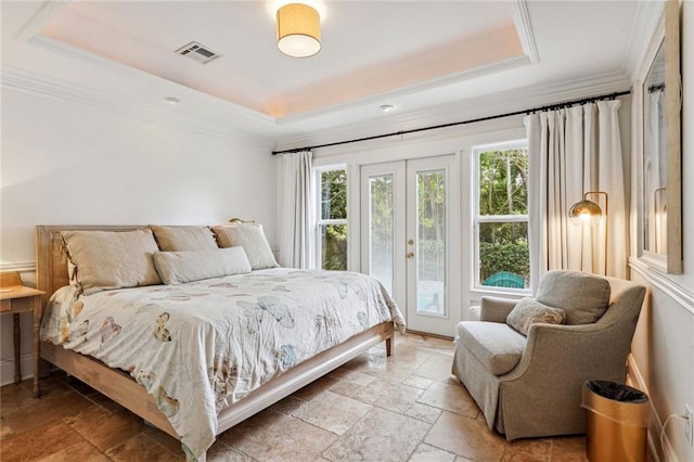 bedroom featuring stone tile floors, visible vents, a raised ceiling, and access to exterior