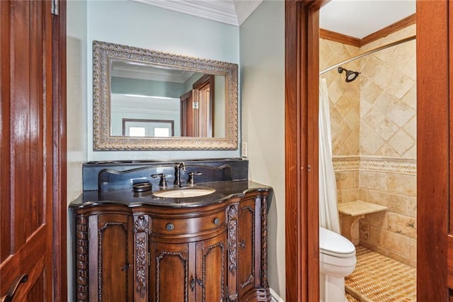 bathroom with vanity, crown molding, toilet, and tiled shower