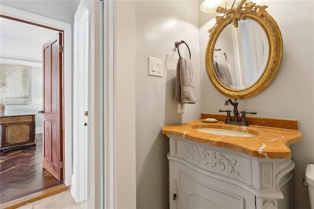 half bath featuring vanity and toilet