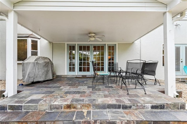 view of patio with french doors, outdoor dining area, a grill, and a ceiling fan